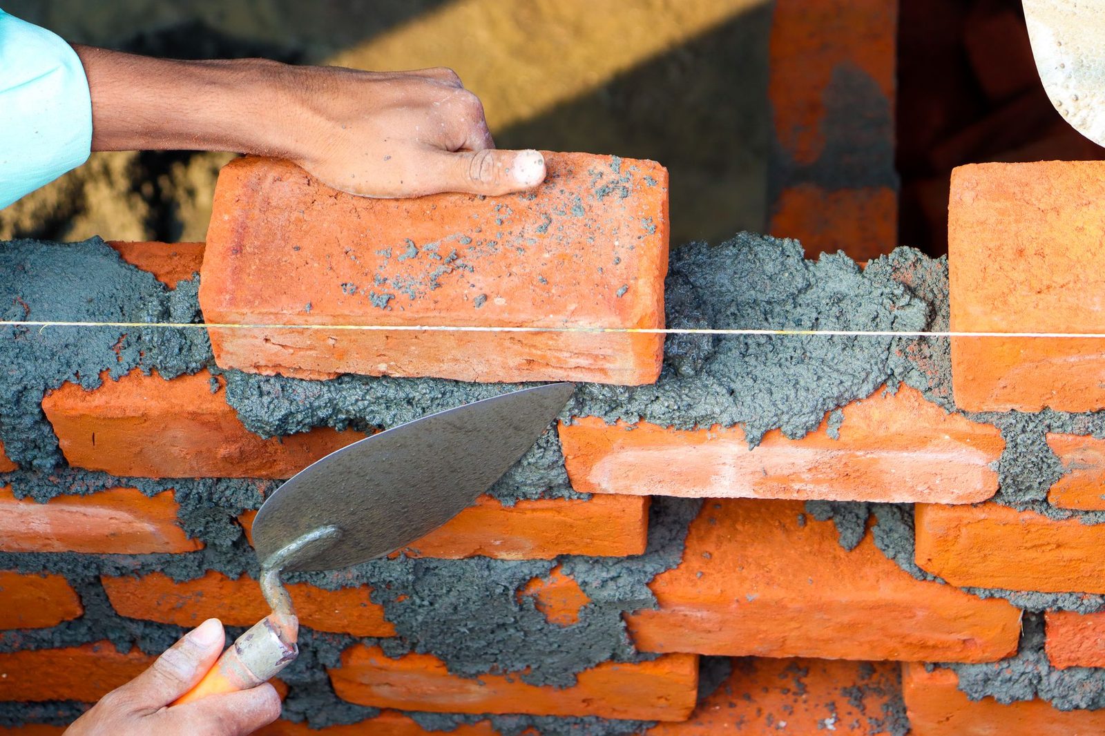 Bricklayer laying bricks on a new wall