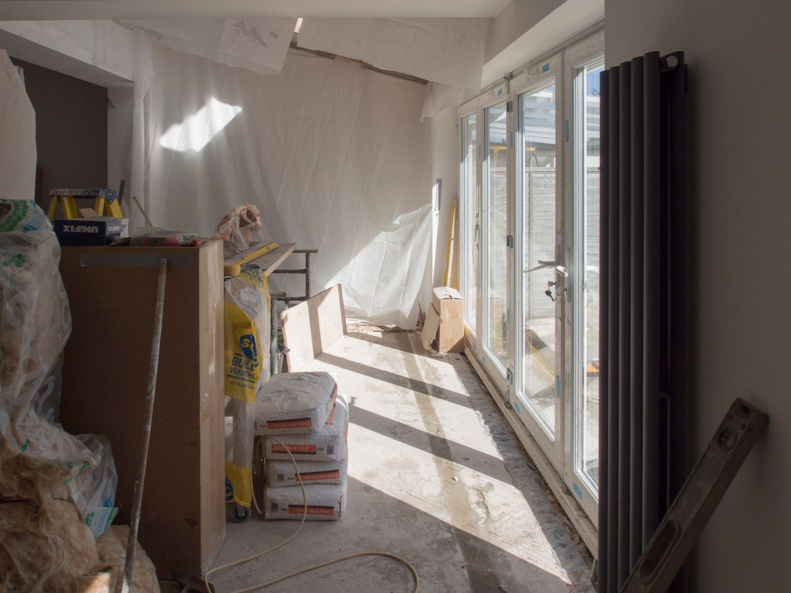 Interior of a house extension under construction with new bifold doors