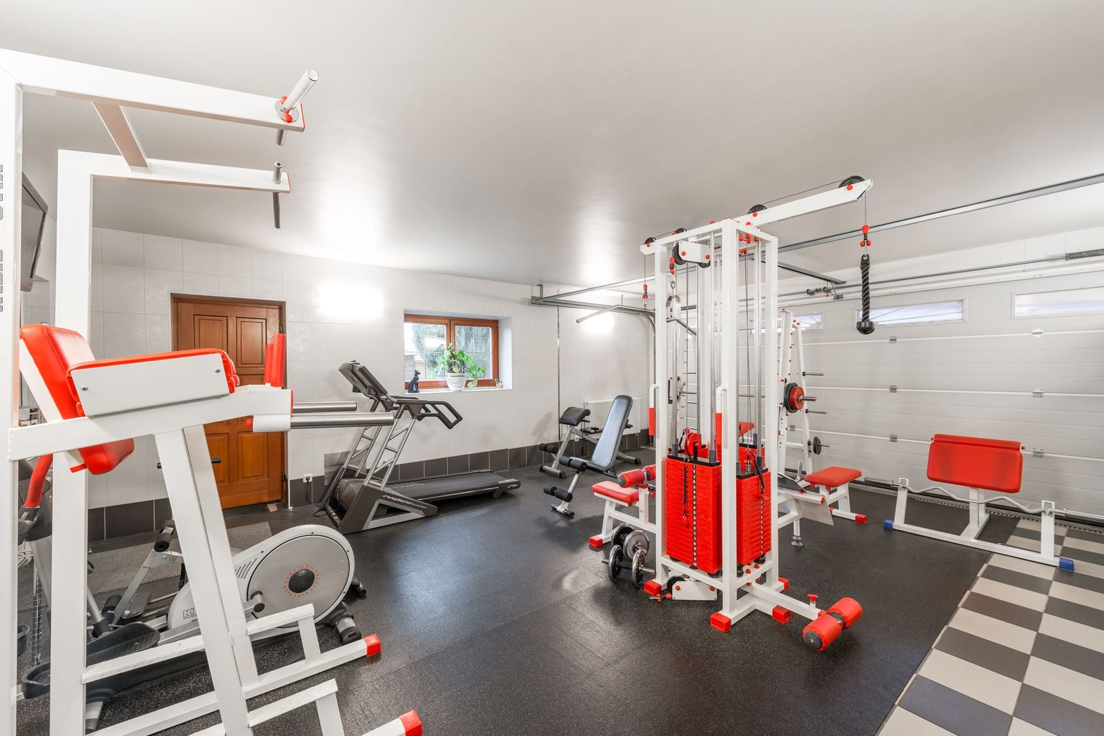 Garage converted into a home gym with fitness equipment